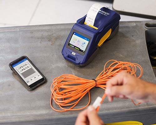 An M611 printer and a mobile app are used to create and print a cable flag label.