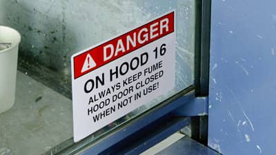 A danger label applied to an industrial oven warning that the hood should always be closed.