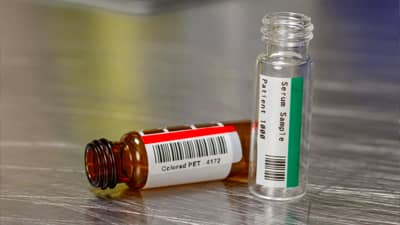 Two vials with a red and green coloured labels.