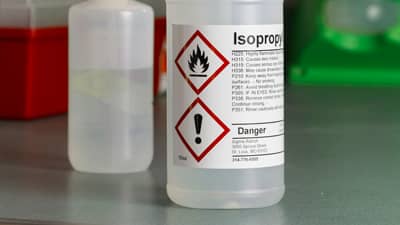 A preprinted GHS label on a bottle of Isopropyl alcohol.