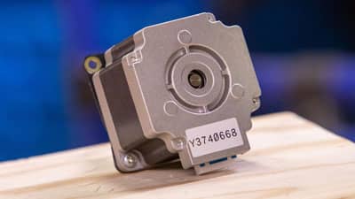 A Brady agressive adhesive label applied to the textured surface of a small motor casing.