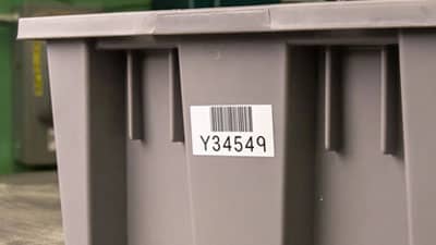 A Brady aggressive adhesive label applied to storage bin.