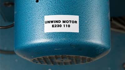 A Brady ultra aggressive polyester label applied to the curved surface of an industrial motor.