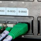 A Brady label applied above a data port on a piece of equipment to identify the port's purpose.