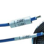 Two Brady heat shrink labels applied to wires to identify their purpose.