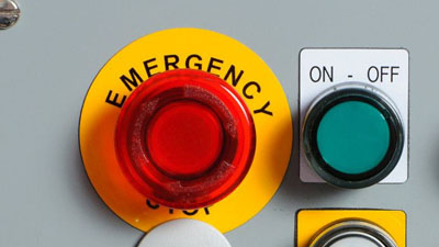 Raised panel labels marking an emergency button and an on / off switch.