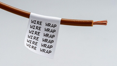 A brown wire with a white wrap around label reading 