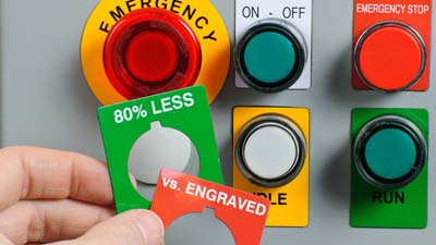 A variety of Brady raised panel labels in different shapes and colours applied to the buttons of a control box.
