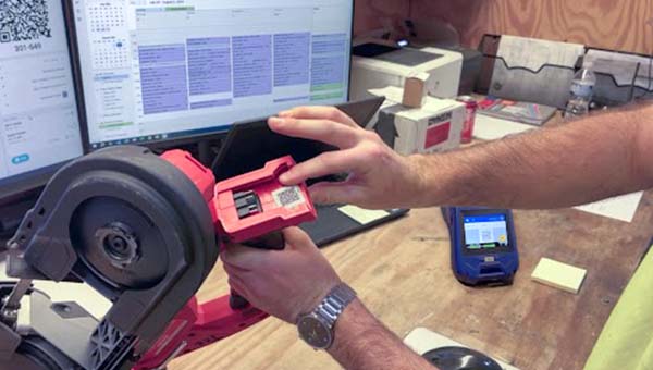 A person points out a label on a tool.